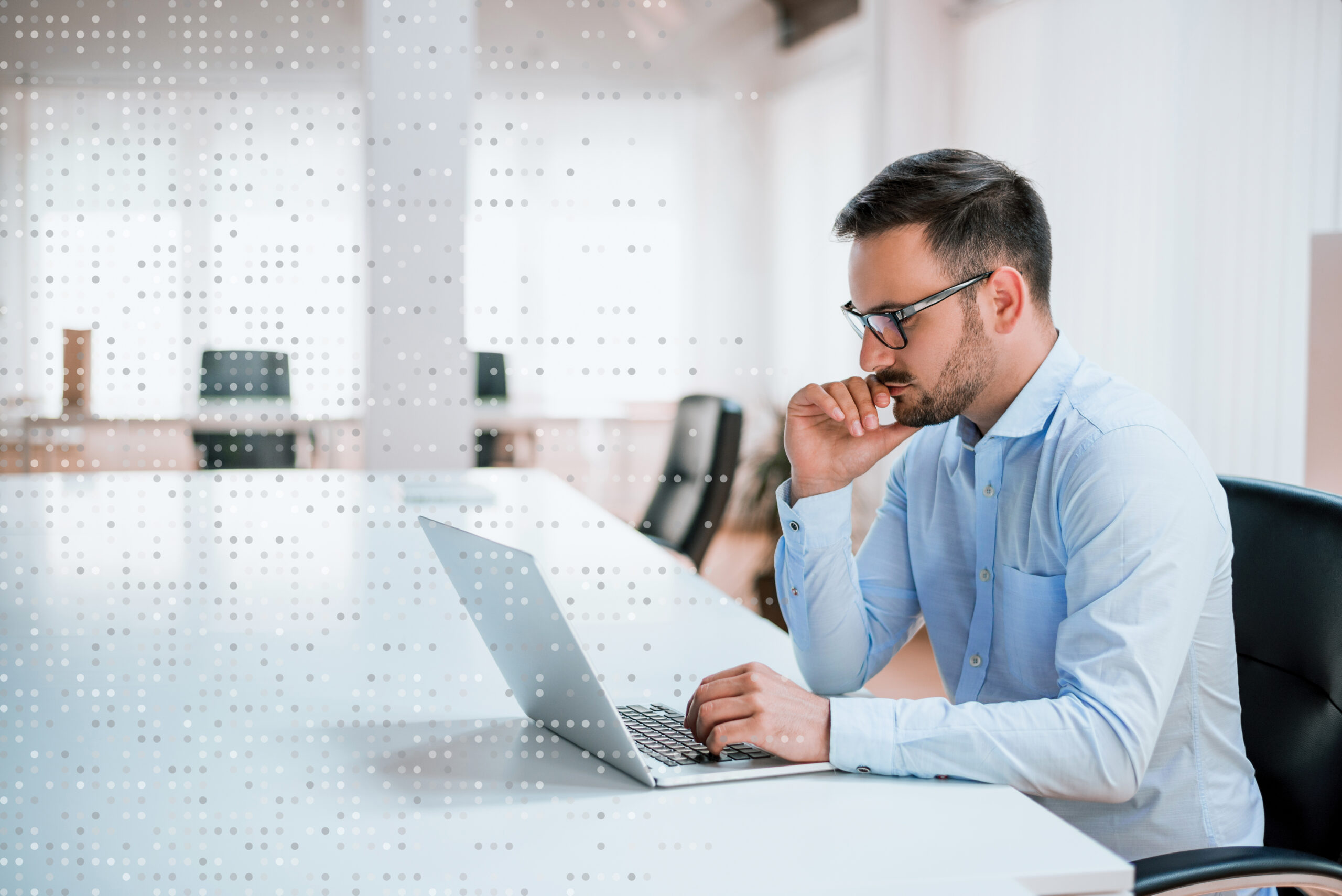 Handsome man working on project at modern office desk