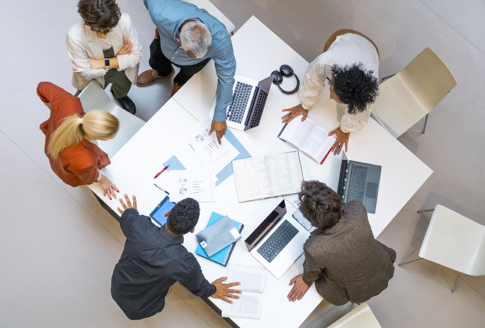group of office workers around a large table